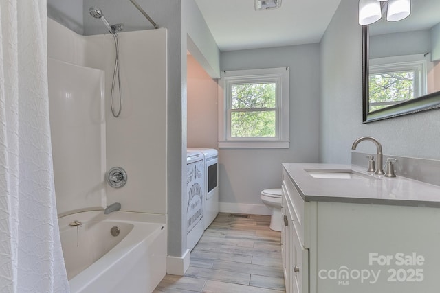 963 Kenham Pl SW, Lenoir, NC 28645 - full bath with baseboards, toilet, shower / bath combo with shower curtain, vanity, and washing machine and dryer