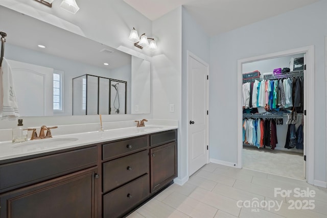 13115 Union Square Dr, Huntersville, NC 28078 - bathroom featuring a sink, double vanity, a walk in closet, and a shower stall