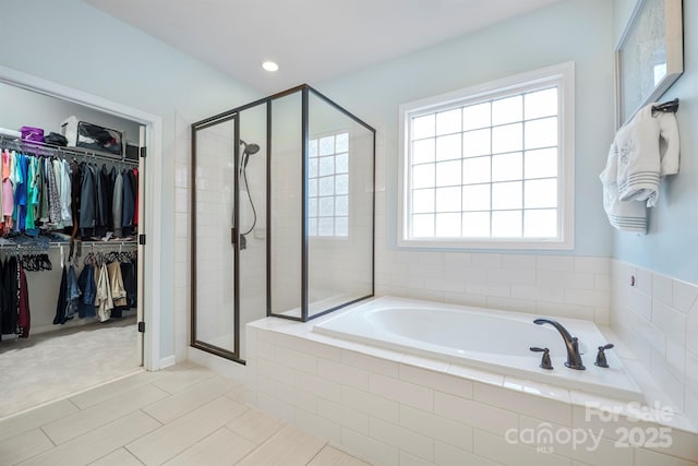 13115 Union Square Dr, Huntersville, NC 28078 - full bathroom featuring a stall shower, a walk in closet, a bath, and recessed lighting