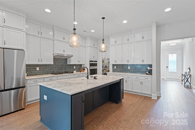 1390 Cedardale Ln, Denver, NC 28037 - kitchen featuring appliances with stainless steel finishes, white cabinets, light wood-style floors, tasteful backsplash, and recessed lighting