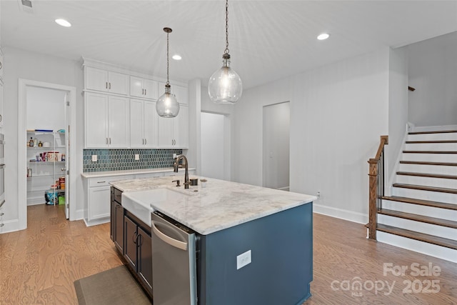 1390 Cedardale Ln, Denver, NC 28037 - kitchen featuring a sink, stainless steel dishwasher, light wood-style flooring, white cabinets, and decorative light fixtures