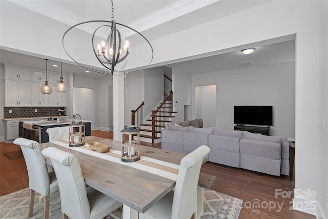 1390 Cedardale Ln, Denver, NC 28037 - dining area featuring stairs, wood finished floors, a chandelier, and crown molding