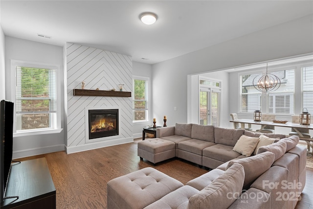 1390 Cedardale Ln, Denver, NC 28037 - living room featuring a fireplace, wood finished floors, a chandelier, and baseboards