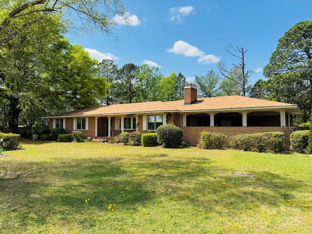 2480 Sumter Hwy, Bishopville, SC 29010 - ranch-style home featuring brick siding, a porch, a chimney, and a front lawn