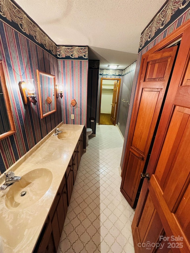2480 Sumter Hwy, Bishopville, SC 29010 - bathroom with wallpapered walls, a sink, a textured ceiling, and tile patterned floors