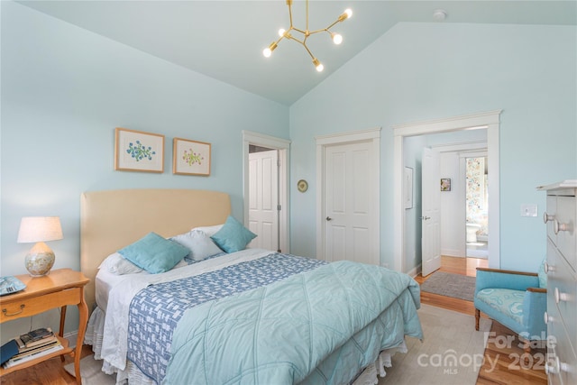 95 Greenwells Glory Dr, Biltmore Lake, NC 28715 - bedroom with a chandelier, high vaulted ceiling, wood finished floors, and baseboards