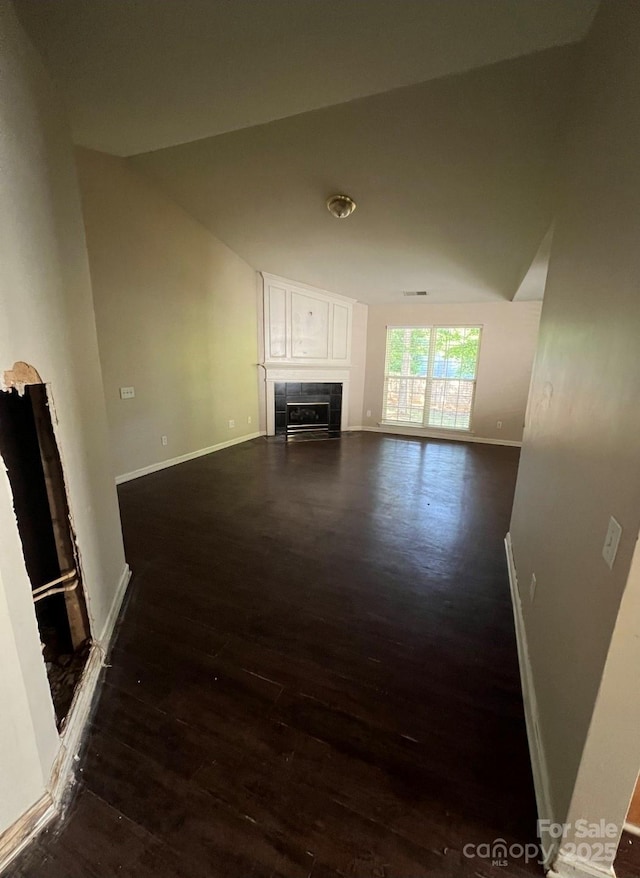 1507 Rumstone Ln, Charlotte, NC 28262 - unfurnished living room featuring dark wood finished floors, baseboards, and a fireplace