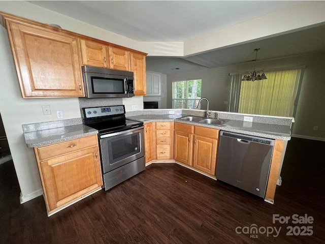 1507 Rumstone Ln, Charlotte, NC 28262 - kitchen with stainless steel appliances, a sink, dark wood-type flooring, and a chandelier