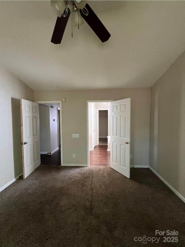 1507 Rumstone Ln, Charlotte, NC 28262 - unfurnished bedroom featuring dark carpet, baseboards, and ceiling fan