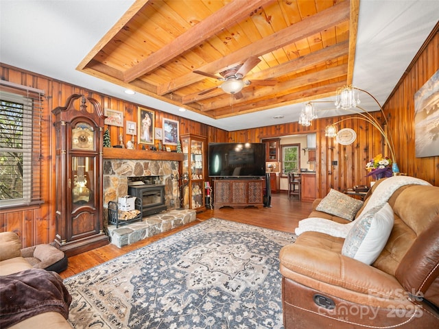 living area with wooden walls, plenty of natural light, and wood ceiling