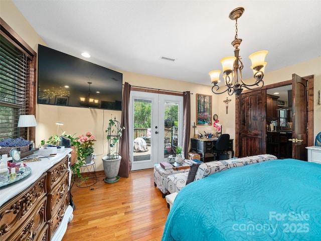 bedroom with a chandelier, light wood-style floors, french doors, access to exterior, and visible vents
