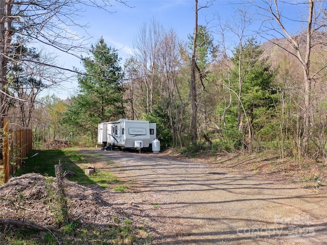 view of road with a wooded view
