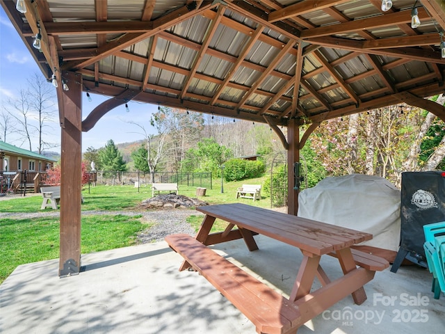 view of patio featuring a gazebo, outdoor dining space, area for grilling, and fence