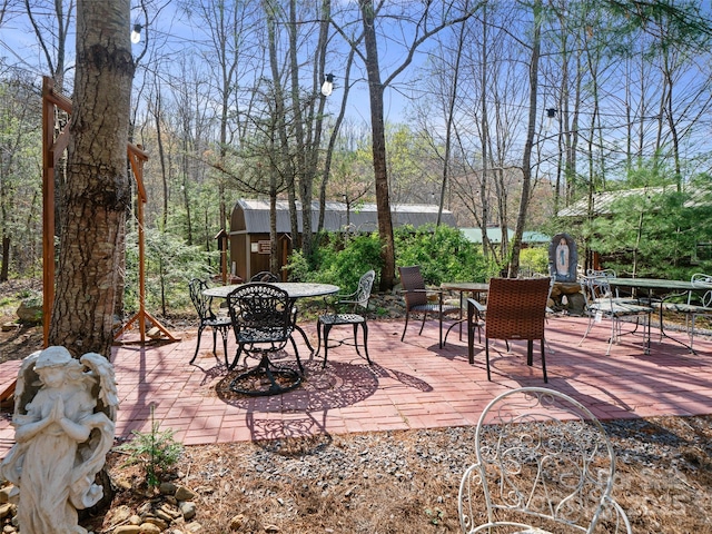 view of patio featuring an outdoor structure and outdoor dining space