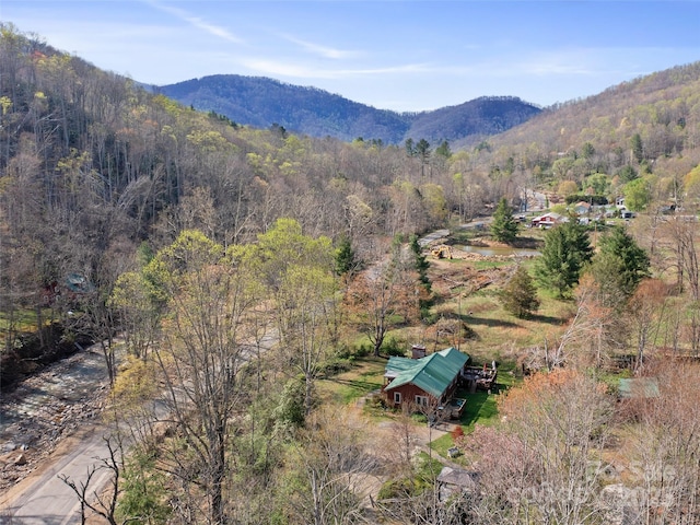 aerial view with a wooded view and a mountain view