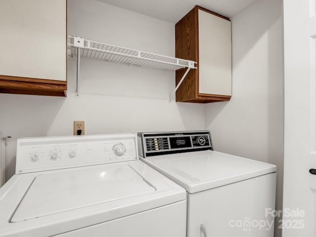 laundry room with cabinet space and separate washer and dryer