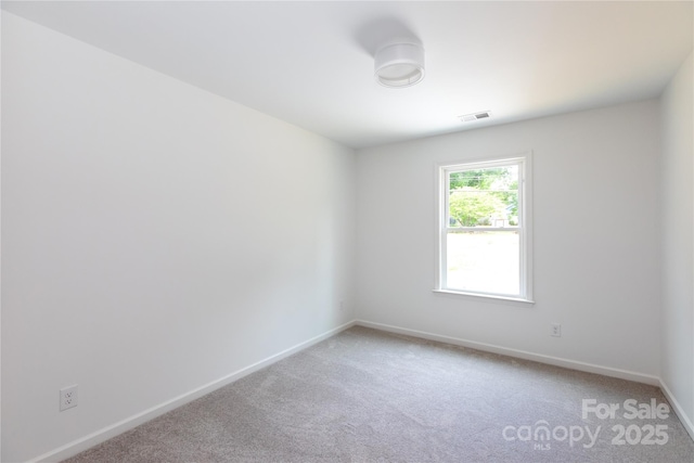 6223 Rockwell Blvd W, Charlotte, NC 28269 - spare room with baseboards, visible vents, and light colored carpet