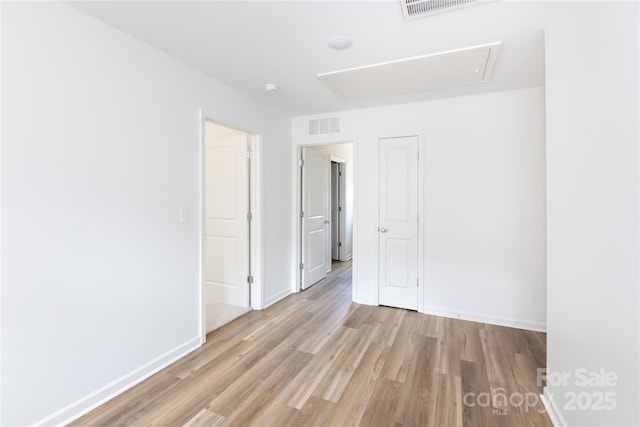 6223 Rockwell Blvd W, Charlotte, NC 28269 - unfurnished room featuring attic access, visible vents, and light wood-style flooring