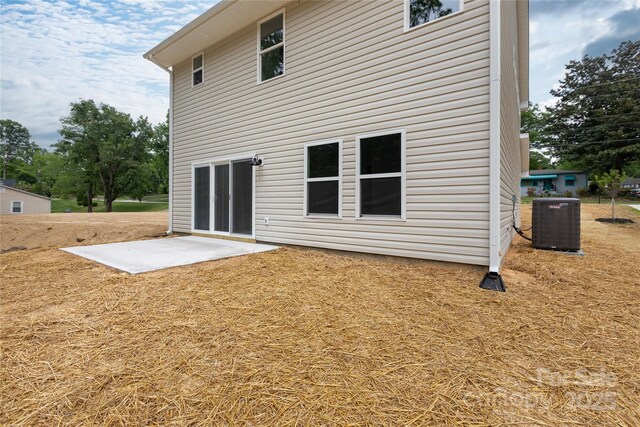 6223 Rockwell Blvd W, Charlotte, NC 28269 - rear view of house with central AC and a patio area