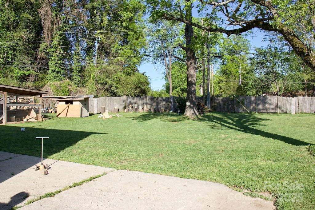 view of yard featuring a patio area and a fenced backyard