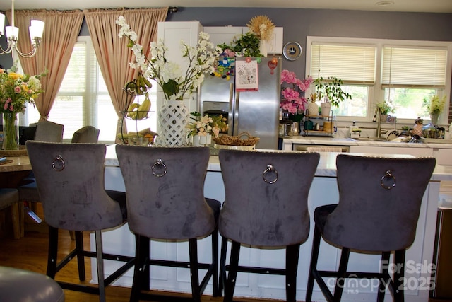 920 Squirrel Hill Rd, Charlotte, NC 28213 - kitchen featuring stainless steel fridge, healthy amount of natural light, a kitchen breakfast bar, and a chandelier