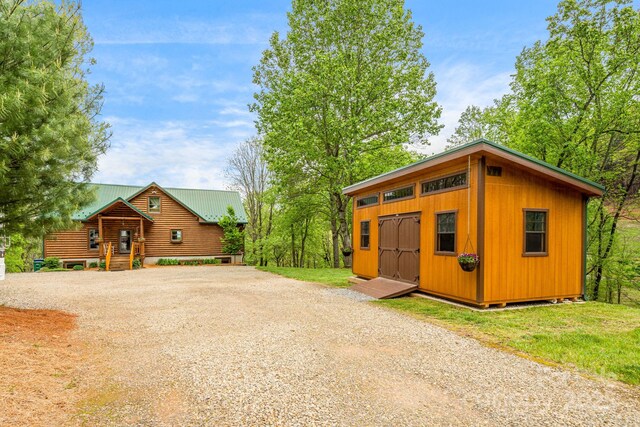 view of front facade featuring an outbuilding and gravel driveway