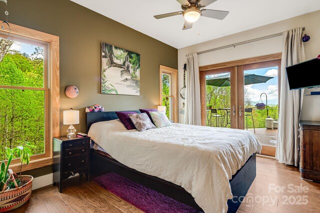 bedroom featuring wood finished floors, access to exterior, and french doors