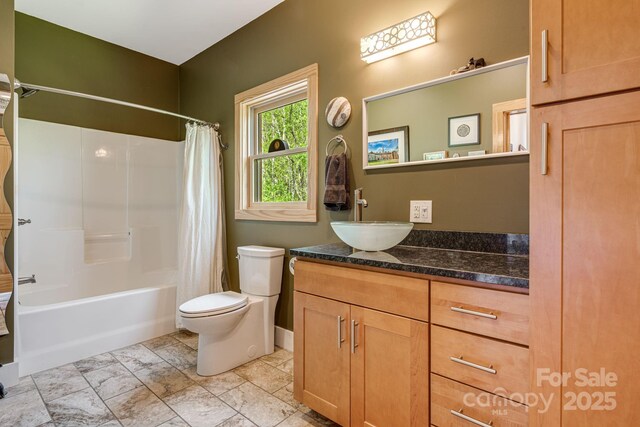 full bathroom with shower / bath combo, toilet, and vanity