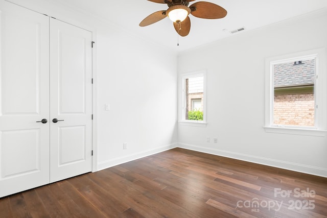 17408 Summer Place Dr, Cornelius, NC 28031 - unfurnished bedroom with crown molding, dark wood finished floors, baseboards, and a ceiling fan