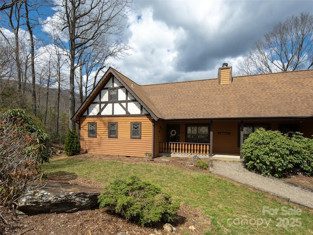 376 Overlook Dr Unit 1, Burnsville, NC 28714 - rear view of property featuring a chimney, a shingled roof, covered porch, and a lawn