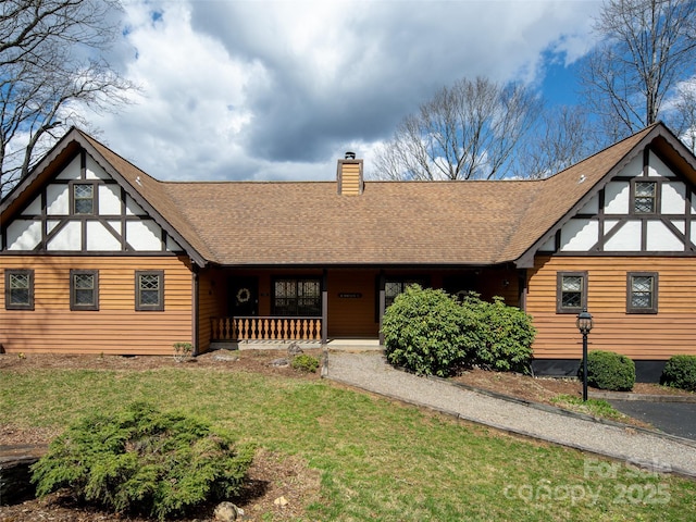 376 Overlook Dr Unit 1, Burnsville, NC 28714 - tudor home featuring roof with shingles, a porch, a chimney, and a front lawn