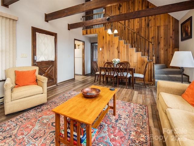 376 Overlook Dr Unit 1, Burnsville, NC 28714 - living area with stairway, lofted ceiling with beams, wooden walls, and wood finished floors