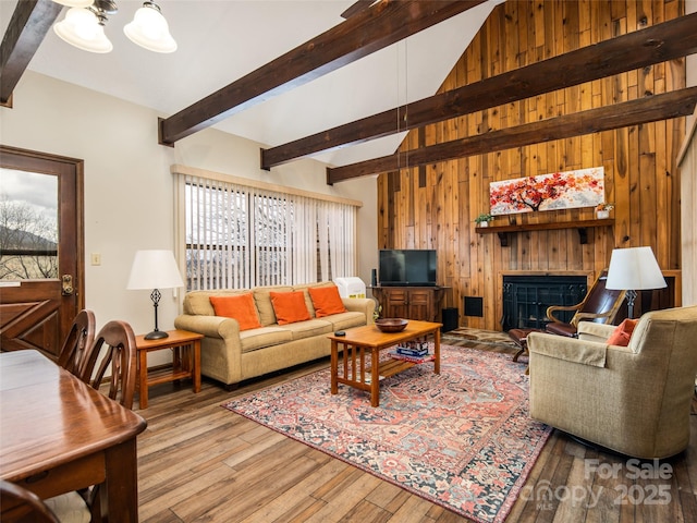 376 Overlook Dr Unit 1, Burnsville, NC 28714 - living room featuring beamed ceiling, a fireplace, wood finished floors, wood walls, and a notable chandelier