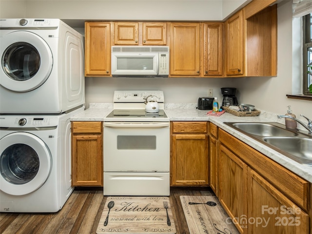 376 Overlook Dr Unit 1, Burnsville, NC 28714 - kitchen with light countertops, white appliances, stacked washer / drying machine, and a sink