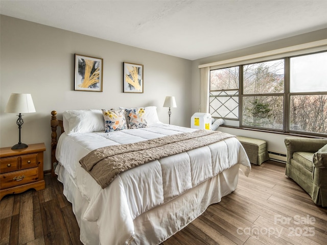 376 Overlook Dr Unit 1, Burnsville, NC 28714 - bedroom featuring a baseboard heating unit and hardwood / wood-style flooring
