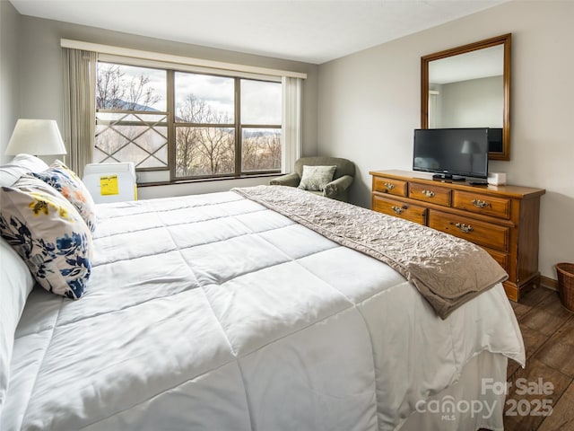 376 Overlook Dr Unit 1, Burnsville, NC 28714 - bedroom with wood finished floors, baseboards, and multiple windows