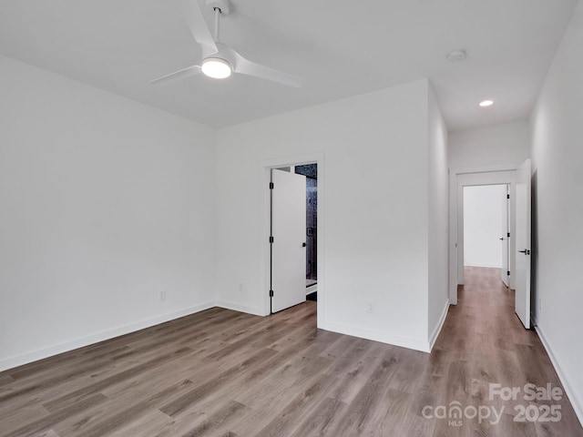 spare room with baseboards, recessed lighting, ceiling fan, and wood finished floors