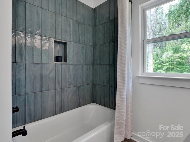 full bath featuring shower / bath combination with curtain and a wealth of natural light