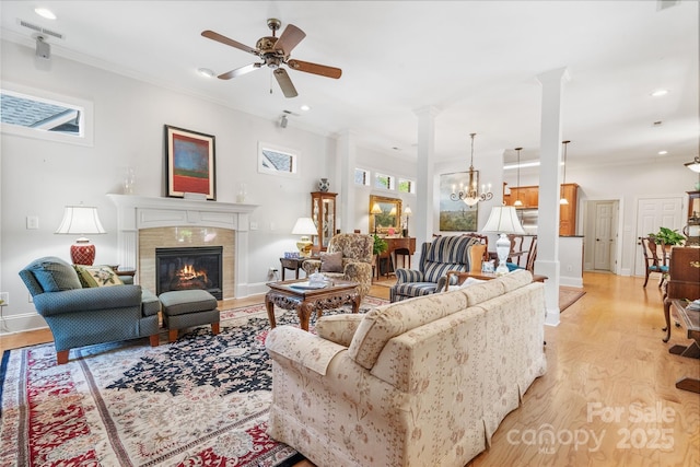 962 Blakeley Walk, Rock Hill, SC 29732 - living room with crown molding, ceiling fan with notable chandelier, light wood-style floors, a fireplace, and visible vents
