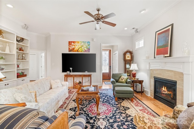 962 Blakeley Walk, Rock Hill, SC 29732 - living room featuring wood finished floors, a ceiling fan, ornamental molding, baseboards, and a tiled fireplace