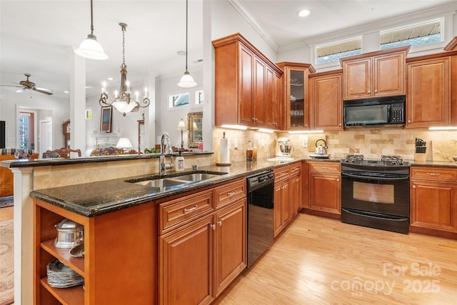 962 Blakeley Walk, Rock Hill, SC 29732 - kitchen featuring a sink, dark stone counters, black appliances, a peninsula, and brown cabinetry