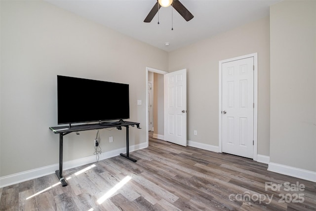 unfurnished bedroom featuring baseboards, ceiling fan, and wood finished floors