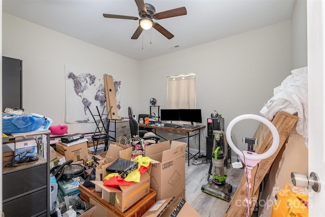 office featuring wood finished floors, a ceiling fan, and visible vents