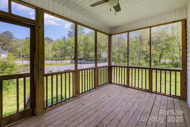 unfurnished sunroom with a ceiling fan