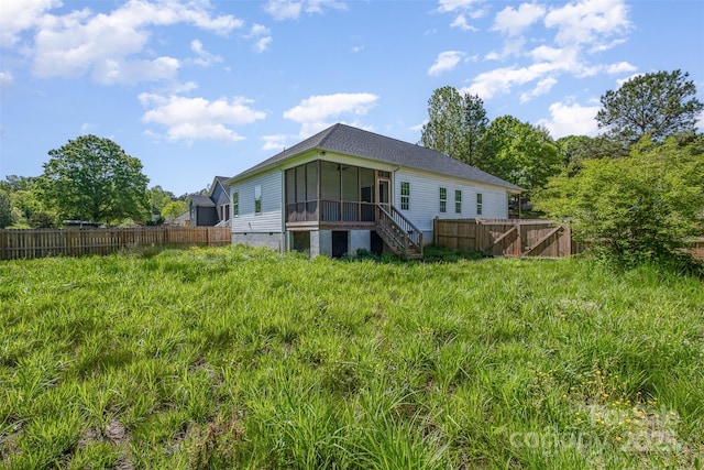 rear view of property featuring fence, stairs, and roof with shingles
