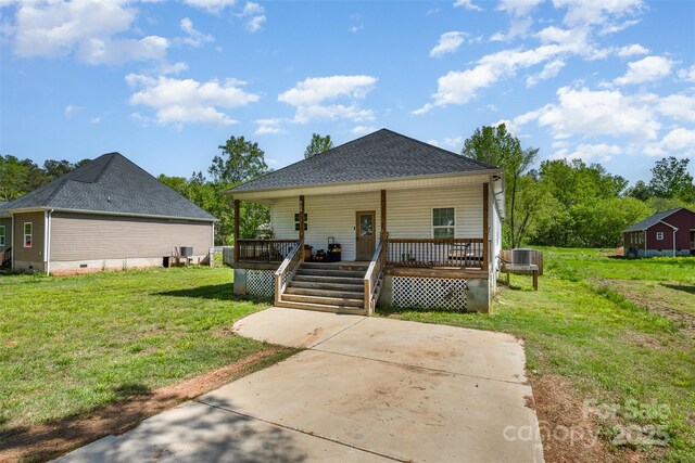 bungalow-style home with crawl space, a front yard, central AC, a shingled roof, and covered porch
