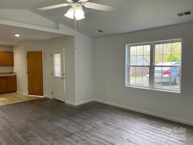 interior space with a healthy amount of sunlight, a ceiling fan, and visible vents