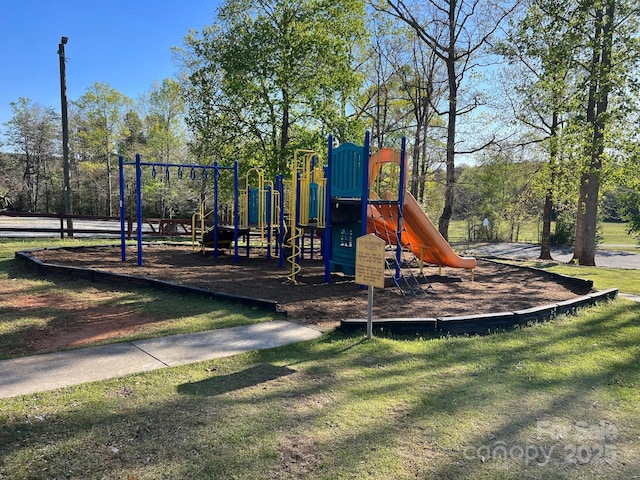 community jungle gym featuring a yard