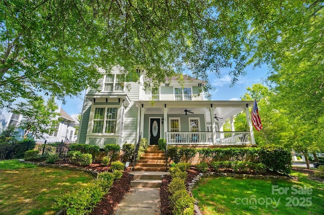 view of front of house with a ceiling fan, covered porch, and stairway