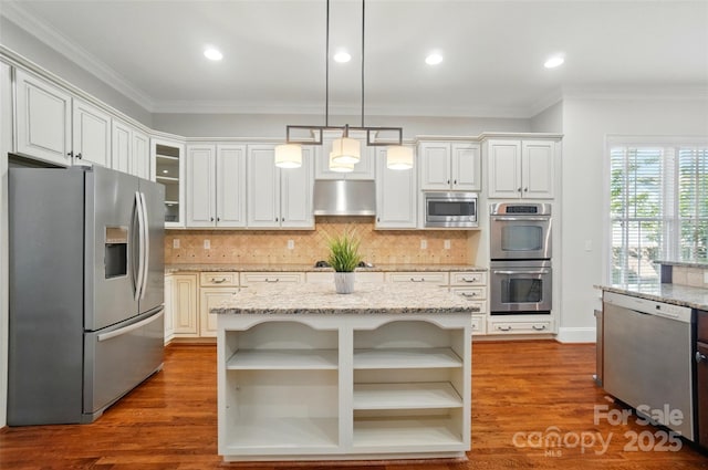 kitchen featuring appliances with stainless steel finishes, ornamental molding, open shelves, and under cabinet range hood